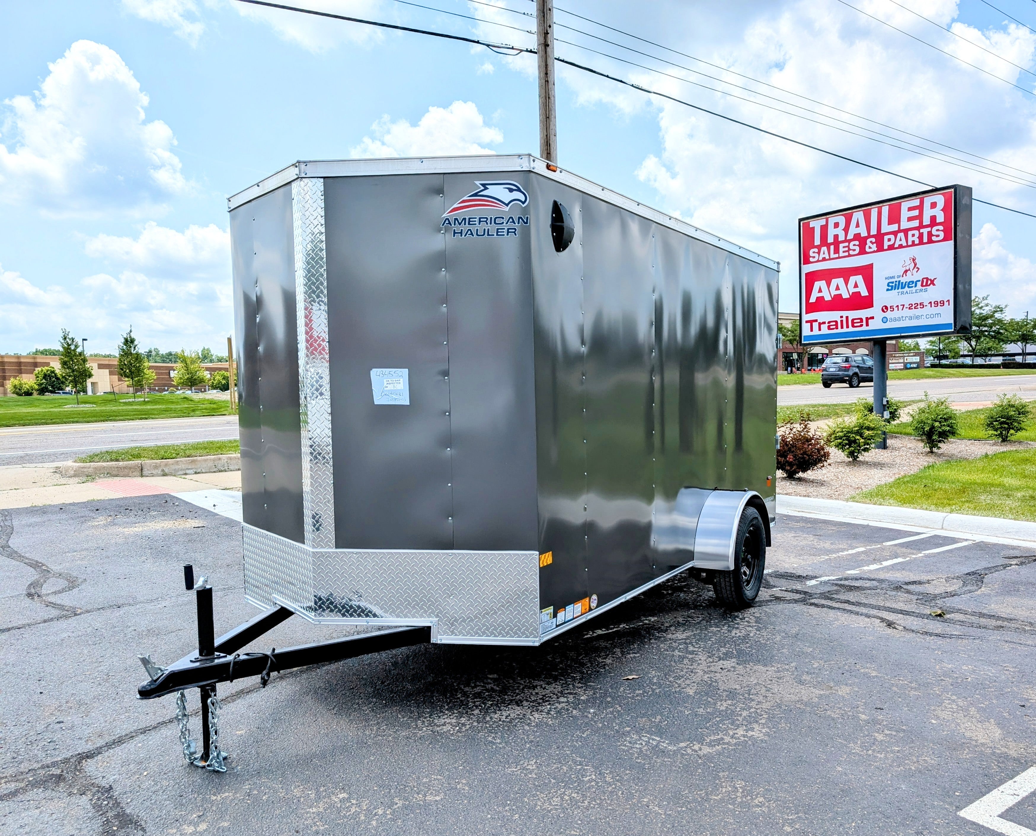 6X12 Enclosed trailer parked on a paved surface with a clear sky at AAA Trailer in Howell mi 