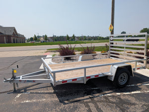 Silver Ox Aluminum utility trailer with wooden floor on a paved road