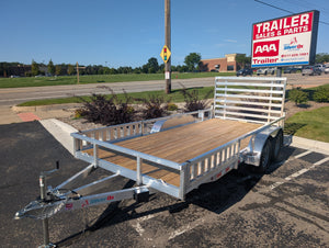 Silver Ox Utility trailer parked on a paved area with a clear sky